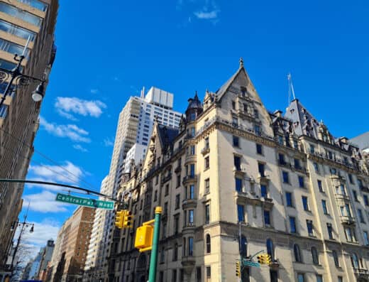 Luxurious historic building with ornate architecture in a bustling cityscape during daytime.