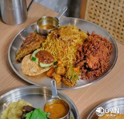 An Ethiopian food platter featuring vibrant rice, spicy minced meat, lentils, and vegetables served with injera bread and flavorful sauce, showcasing authentic Ethiopian cuisine.