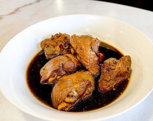 Rich Filipino braised pork adobo with soy sauce and vinegar, tender meat, and flavorful sauce, perfect for Filipino cuisine lovers.
