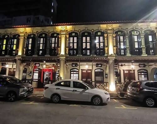 A beautifully illuminated historic colonial-style building at night with ornate architecture and vibrant lighting, showcasing its classic charm and intricate details.