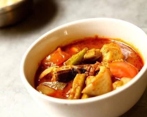 A flavorful bowl of spicy fish stew featuring fresh vegetables and tender fish pieces in a rich, savory broth. Perfect for healthy, comforting meals and seafood lovers.